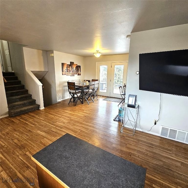 97 Ghost Canyon Ct, Belgrade, MT 59714 - living room with visible vents, wood finished floors, and stairs