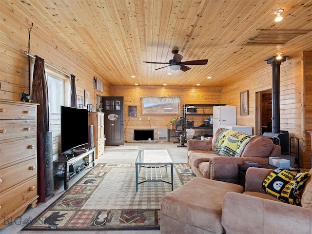 193 Tobe Rd, Ennis, MT 59729 - living area featuring a wood stove, wood ceiling, wood walls, a ceiling fan, and recessed lighting