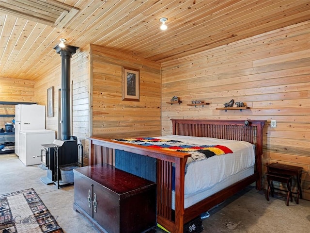 193 Tobe Rd, Ennis, MT 59729 - bedroom with wood ceiling, wood walls, carpet floors, and a wood stove