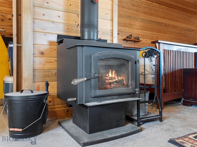 193 Tobe Rd, Ennis, MT 59729 - detailed view of a wood stove, wooden walls, and concrete flooring
