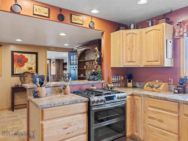 193 Tobe Rd, Ennis, MT 59729 - kitchen featuring range with two ovens, light brown cabinetry, a peninsula, recessed lighting, and light countertops
