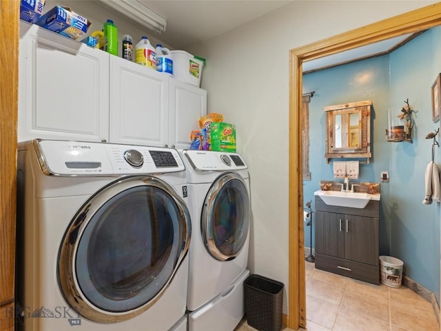 193 Tobe Rd, Ennis, MT 59729 - washroom featuring washing machine and clothes dryer, cabinet space, and light tile patterned floors