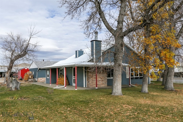 back of property featuring a yard and a patio area