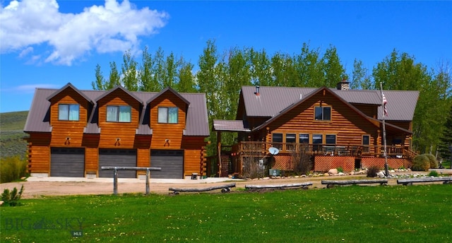 155 Moose Run, Polaris, MT 59746 - view of front of property with a garage, log siding, driveway, a chimney, and a front yard