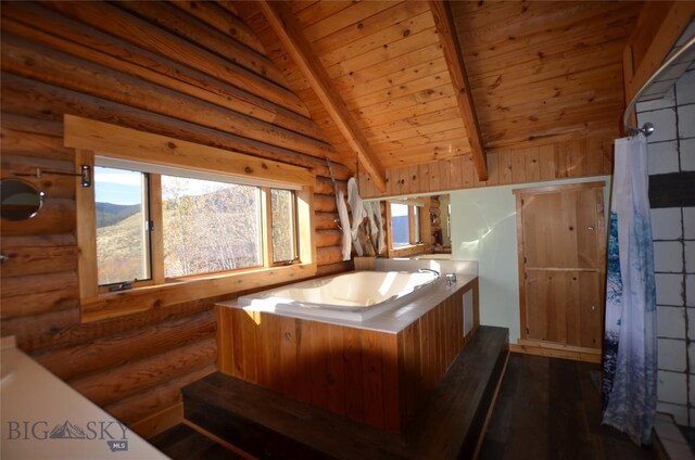 155 Moose Run, Polaris, MT 59746 - bathroom with log walls, wooden ceiling, a garden tub, and wood finished floors