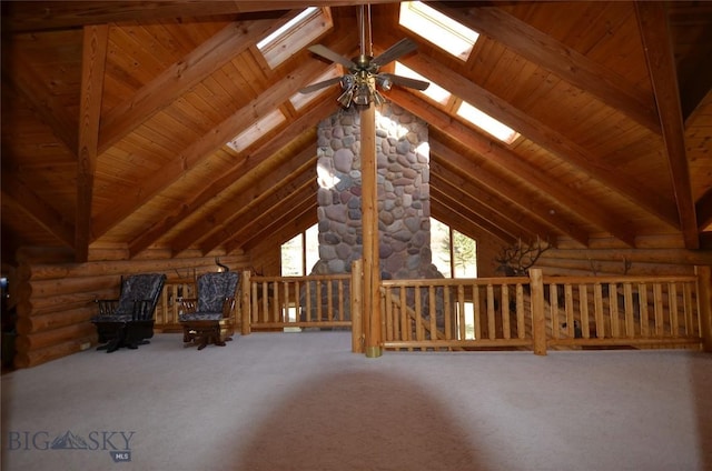 155 Moose Run, Polaris, MT 59746 - unfurnished room with a skylight, log walls, carpet flooring, wood ceiling, and a ceiling fan