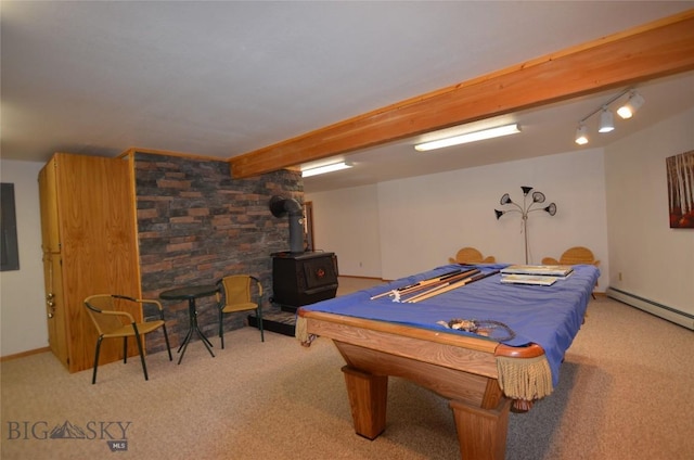 155 Moose Run, Polaris, MT 59746 - recreation room featuring light carpet, a wood stove, electric panel, and a baseboard radiator