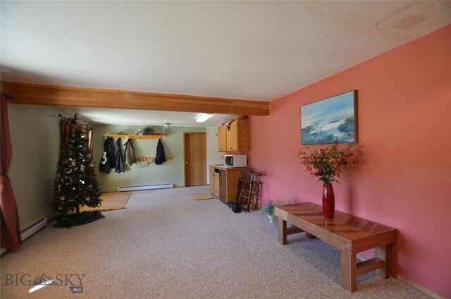 interior space featuring a baseboard heating unit and light carpet