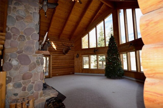 155 Moose Run, Polaris, MT 59746 - unfurnished living room with high vaulted ceiling, a wooden ceiling with exposed beams, healthy amount of natural light, carpet, and rustic walls