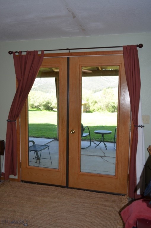 doorway to outside featuring french doors, a healthy amount of sunlight, and carpet floors