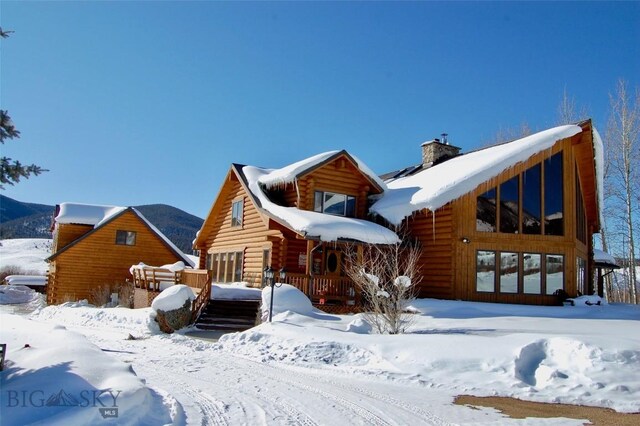 155 Moose Run, Polaris, MT 59746 - view of front of property featuring a chimney, log exterior, and a deck