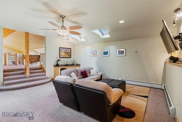 living room featuring a baseboard radiator, carpet, vaulted ceiling with skylight, and ceiling fan