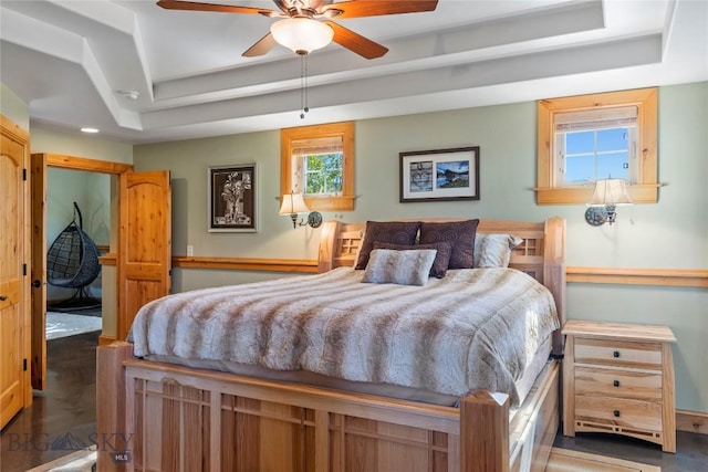 bedroom featuring ceiling fan and a tray ceiling