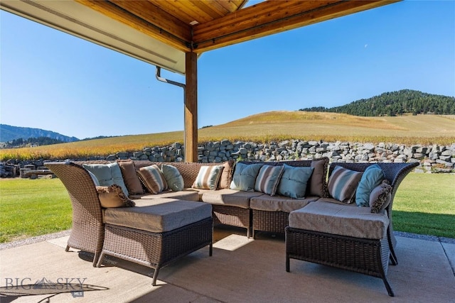 view of patio / terrace with an outdoor hangout area and a mountain view