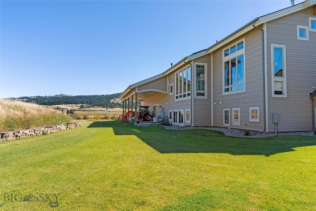 rear view of house with a yard