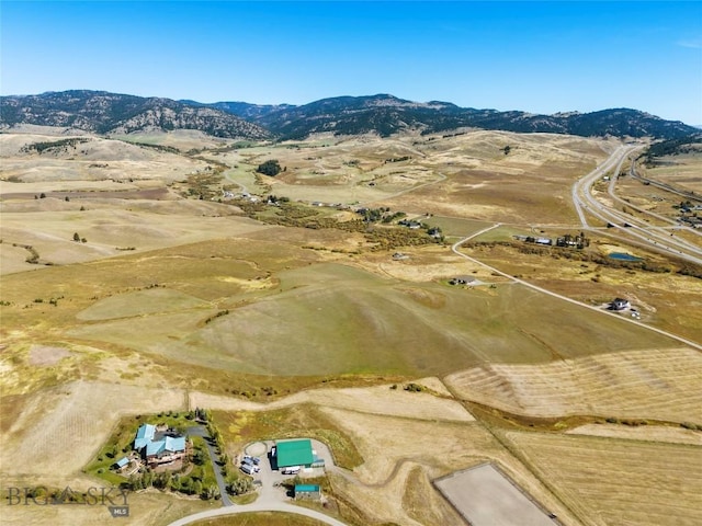 birds eye view of property with a mountain view and a rural view