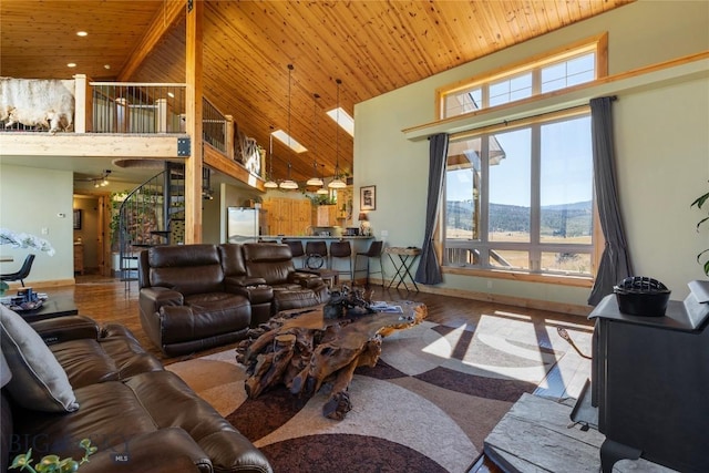 living room featuring hardwood / wood-style flooring, a mountain view, wooden ceiling, and high vaulted ceiling