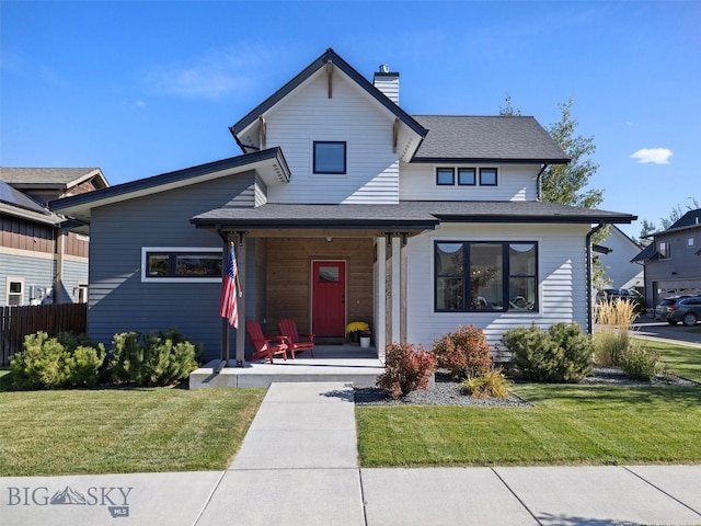 view of front of house with a front yard and covered porch