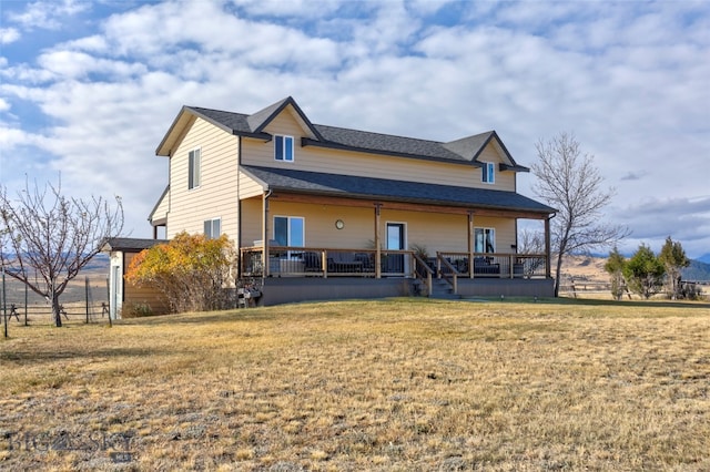 back of house with a deck and a yard