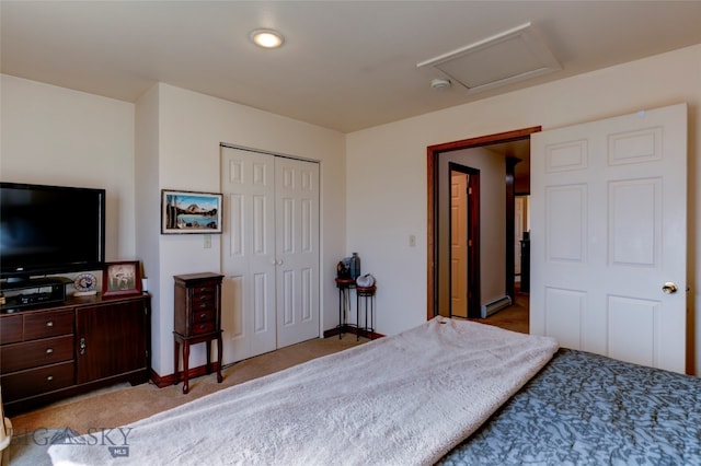 carpeted bedroom featuring a closet and baseboard heating