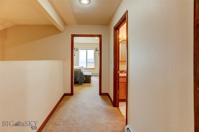 corridor featuring lofted ceiling with beams and light colored carpet