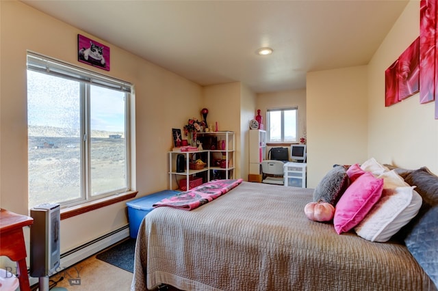 bedroom with carpet floors and baseboard heating