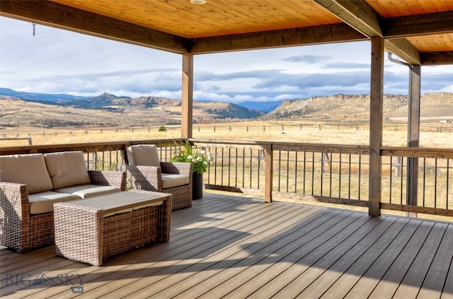 deck featuring a mountain view, a rural view, and an outdoor hangout area