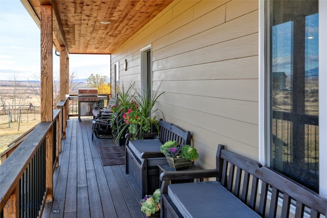 wooden terrace featuring grilling area