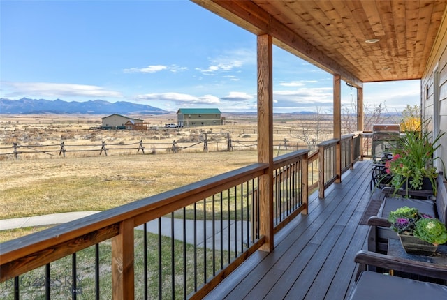 wooden terrace featuring a mountain view and a rural view