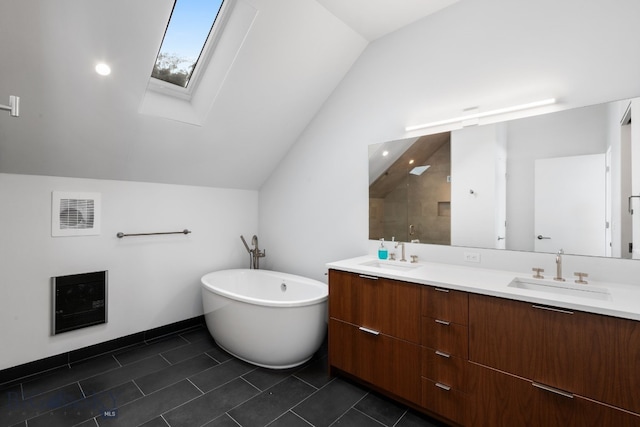 bathroom featuring a bath, lofted ceiling with skylight, tile patterned flooring, and vanity