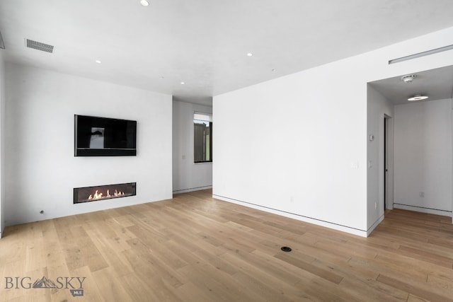 unfurnished living room featuring light hardwood / wood-style floors