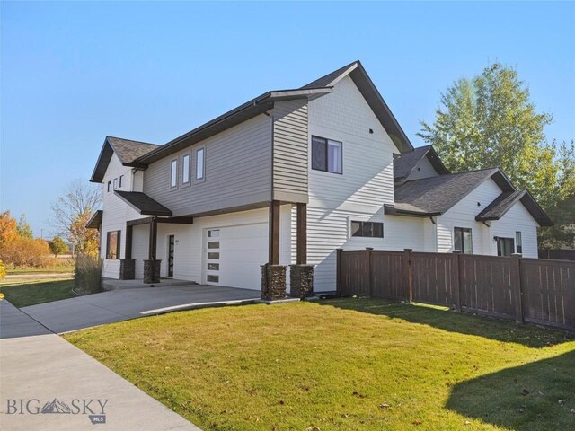 1015 Golden Gate Ave Unit A, Bozeman, MT 59718 - view of side of property with a garage, concrete driveway, and stone siding