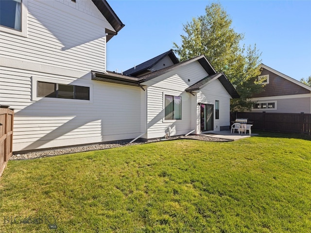 rear view of house with a yard and a patio area