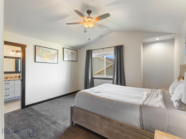 carpeted bedroom featuring connected bathroom, vaulted ceiling, and ceiling fan