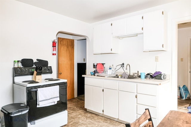 kitchen with white cabinets, sink, and white range with electric cooktop