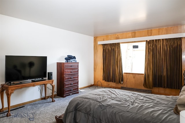 bedroom with a baseboard heating unit and carpet floors