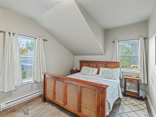 bedroom featuring light hardwood / wood-style flooring, multiple windows, baseboard heating, and lofted ceiling