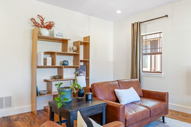 sitting room with wood-type flooring