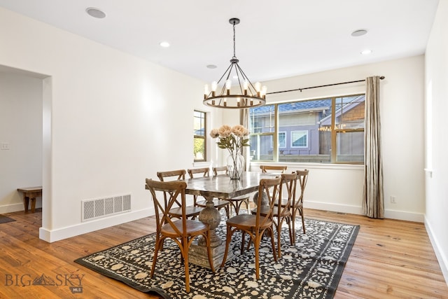 dining area featuring a chandelier and light hardwood / wood-style floors