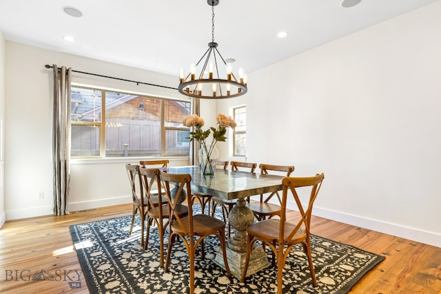 dining room featuring light hardwood / wood-style floors and a chandelier