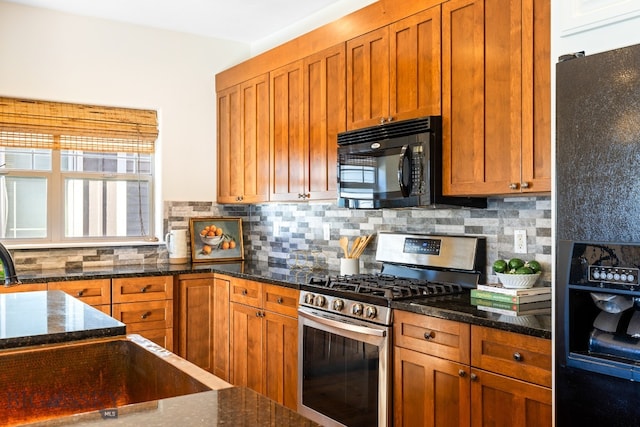 kitchen with black appliances, tasteful backsplash, and dark stone countertops