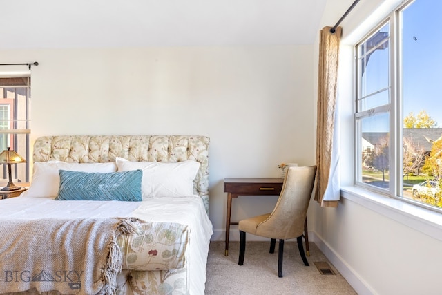 bedroom featuring light carpet