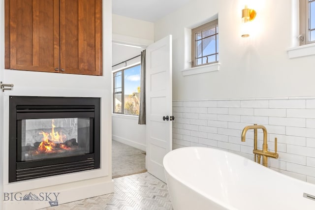 bathroom featuring a tub and tile walls