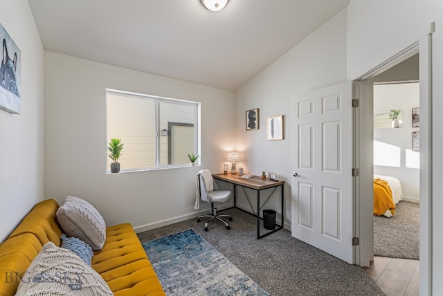 home office featuring lofted ceiling and carpet flooring