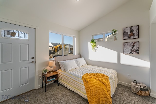 bedroom with dark carpet and lofted ceiling