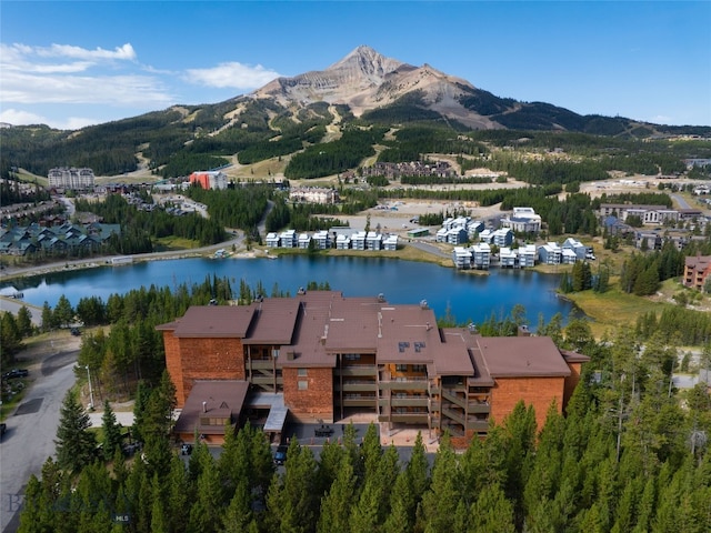 drone / aerial view with a water and mountain view