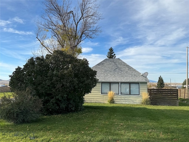 view of property exterior with a lawn