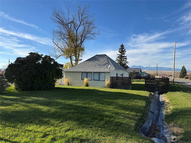 view of side of property with a yard