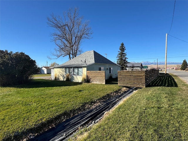 view of side of home featuring a yard