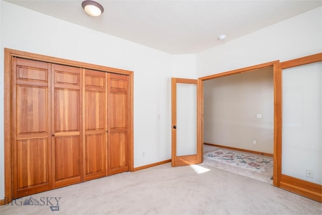 unfurnished bedroom with light colored carpet